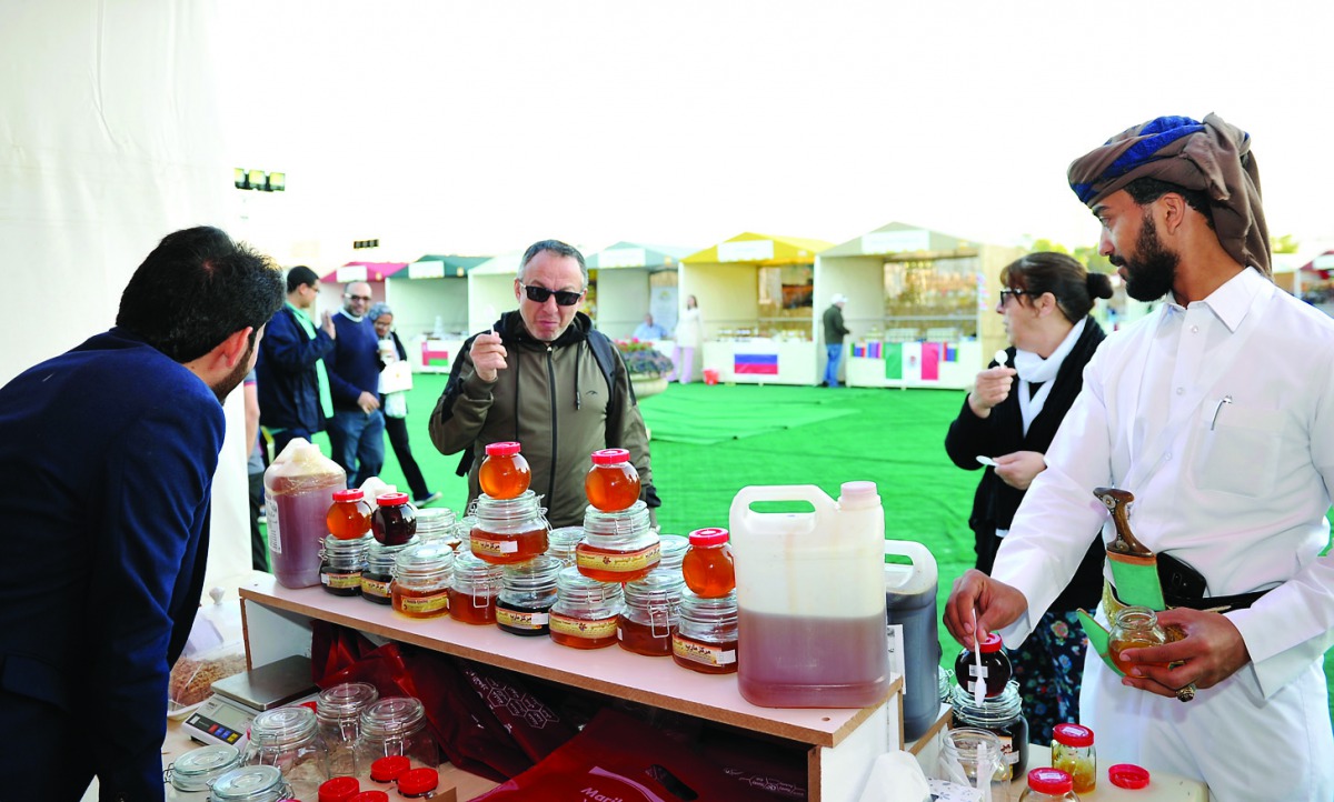 Visitors tasting unique honey varieties at the Third Souq Waqif Honey Exhibition 2020.  
Pic: Salim Matramkot/The Peninsula
