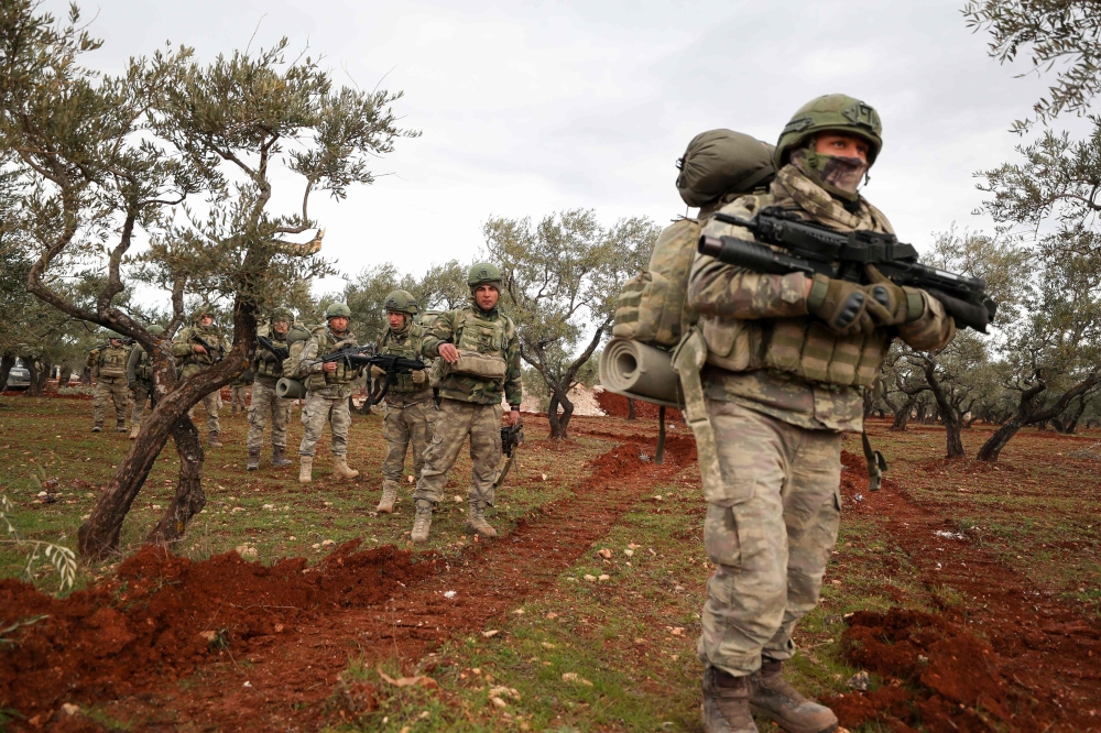 Turkish soldiers gather in the village of Qaminas, about 6 kilometres southeast of Idlib city in northwestern Syria on February 10, 2020.  AFP / Omar HAJ KADOUR