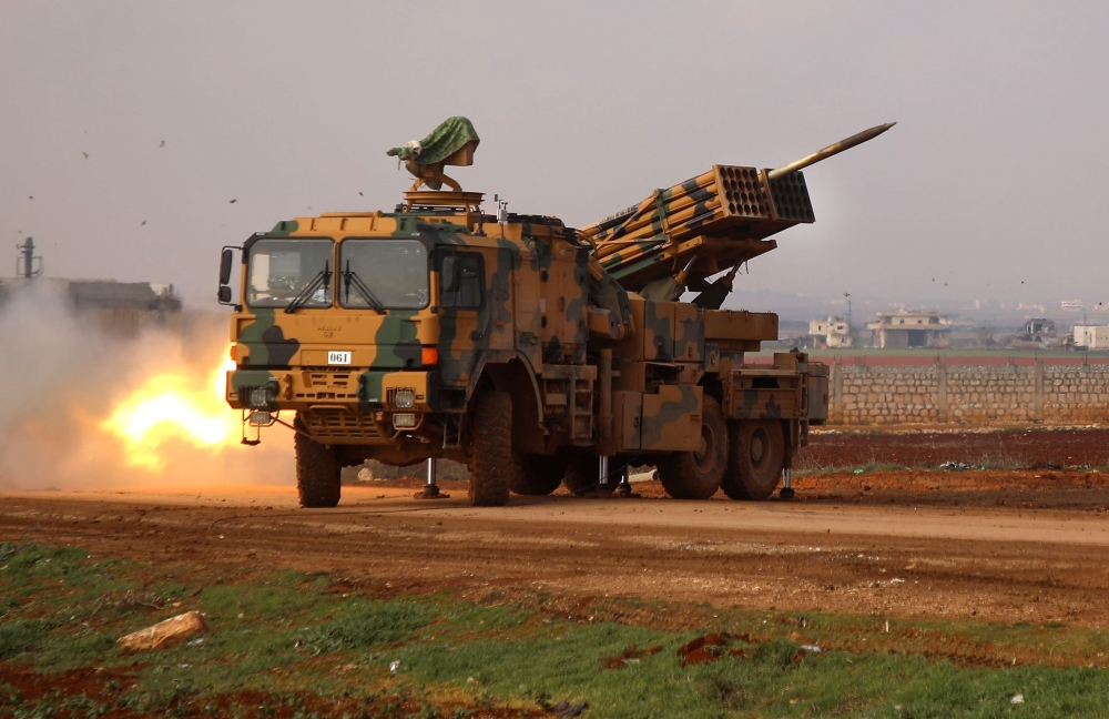 A Turkish military mobile rocket launcher fires from a position near the village of Miznaz, on the eastern outskirts of Syria's Aleppo province, on February 14, 2020, at Syrian government forces' positions in the countryside of Aleppo province. / AFP / AA