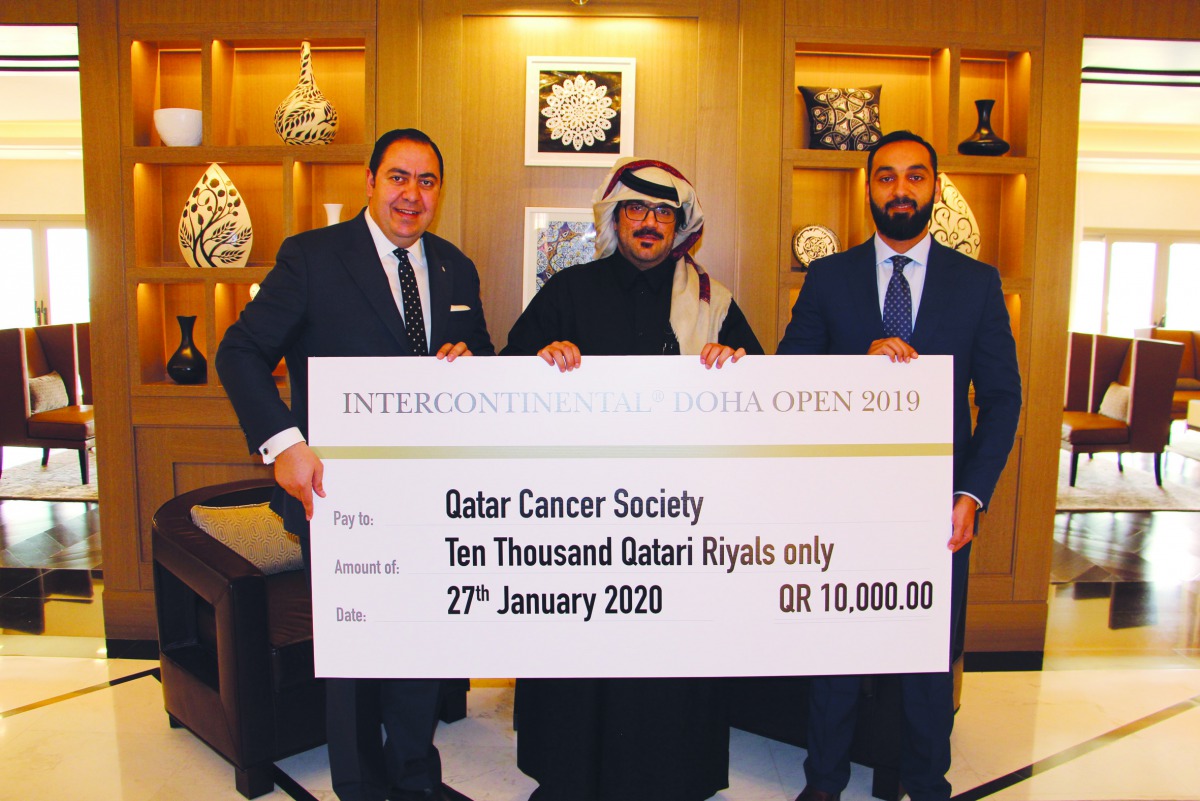 Officials handing over the cheque to Qatar Cancer Society at the Inter-Continental Doha Hotel & Residences.