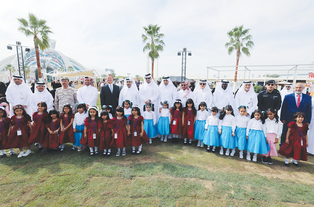 The President of Kahramaa, Eng. Essa bin Hilal Al Kuwari, and other officials and guests with schoolchildren at the opening of the fourth Tarsheed Carnival at Kahramaa Awareness Park, yesterday. 