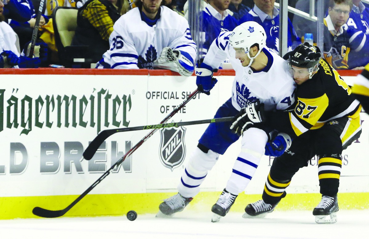 Toronto Maple Leafs left wing Pierre Engvall (47) skates with the puck against pressure from Pittsburgh Penguins center Sidney Crosby (87) during the third period at PPG PAINTS Arena. Pittsburgh won 5-2. Credit: Charles LeClaire-USA TODAY Sports
