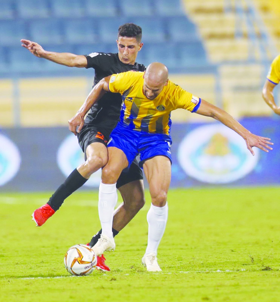 Players of Al Gharafa and Umm Salal vie for ball possession in this file picture.