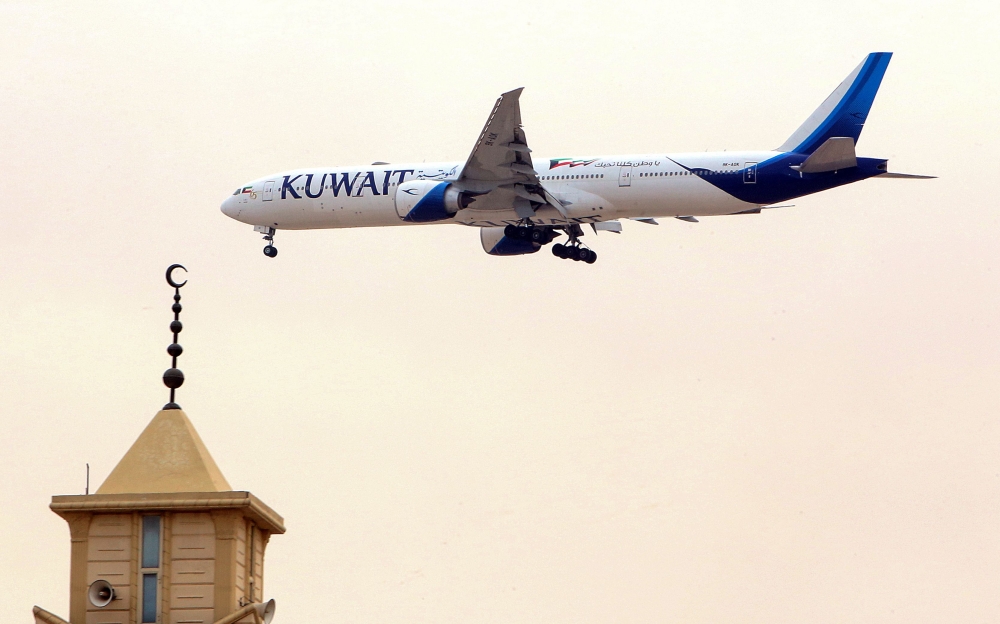 (FILES) In this file photo taken on March 13, 2019, a Kuwait Airways Boeing B777 aircraft prepares to land at Kuwait International Airport in Kuwait City. AFP / Yasser Al-Zayyat