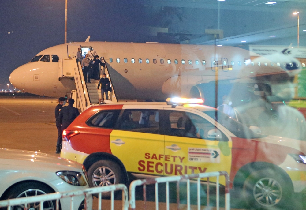 Kuwaitis coming back from Iran leave the air plane at Sheikh Saad Airport in Kuwait City, on February 22, 2020, before being taken to a hospital to be tested for coronavirus. AFP / YASSER AL-ZAYYAT