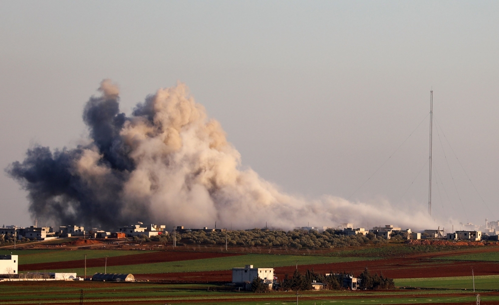 Smoke billows above the rebel-controlled village of Salihiyah near the regime-controlled town of Saraqeb, east of the Idlib province in northwestern Syria, on February 26, 2020, during air stikes by pro-regime forces. / AFP / Omar HAJ KADOUR