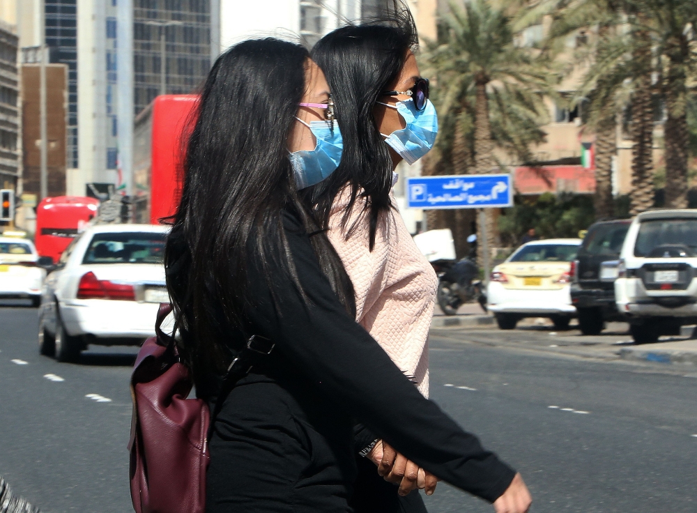 People wear protective masks in Kuwait City on February 27, 2020 amidst a world epidemic of cononavirus COVID-19. AFP / YASSER AL-ZAYYAT