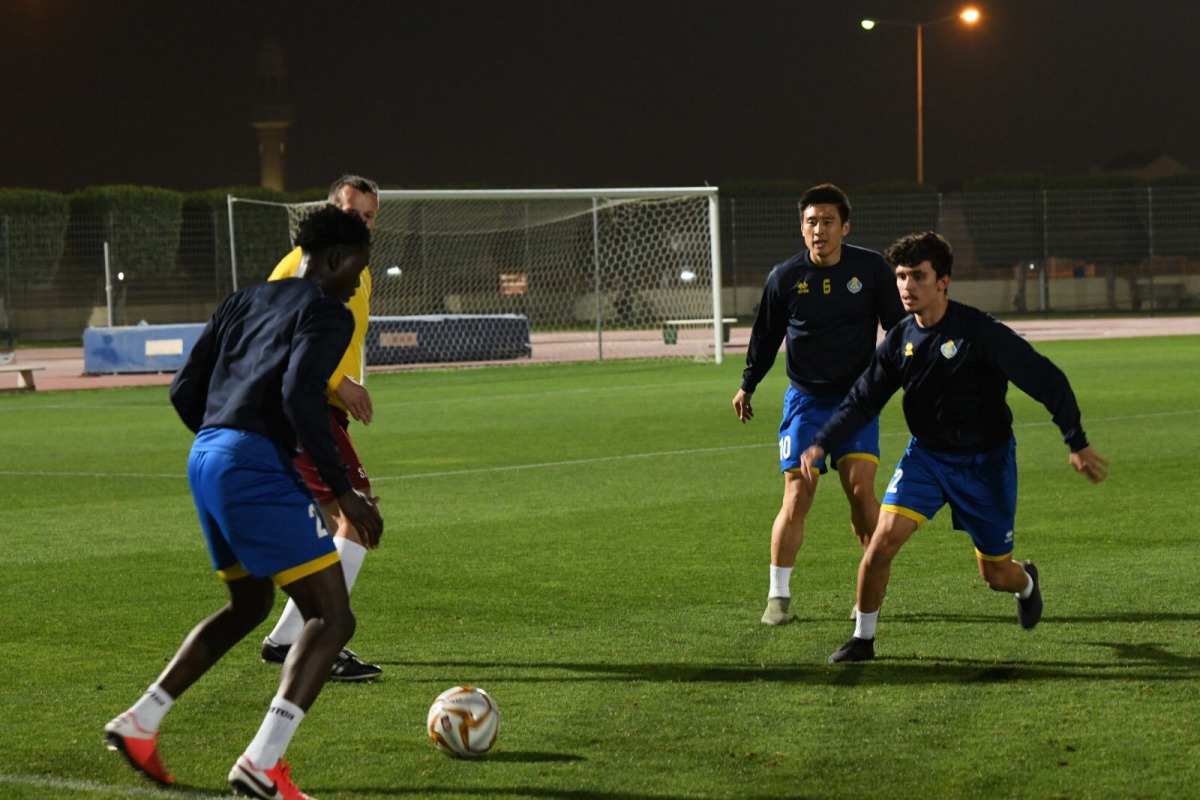 Al Gharafa's players during a training session ahead of their game against Al Wakrah. INSET: Coach Slavisa Jokanovic supervising a training session. 