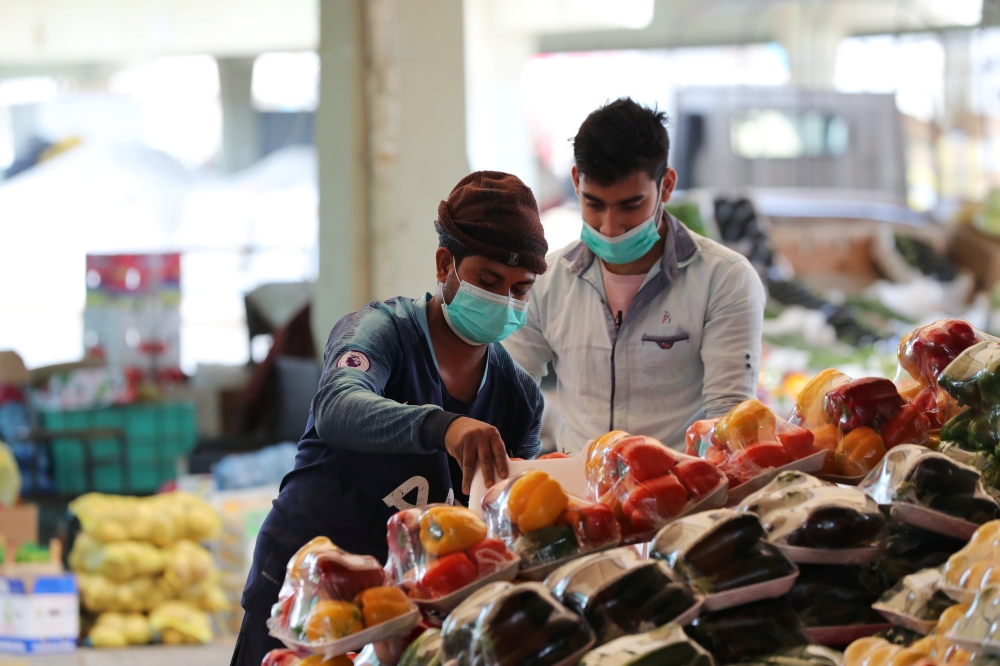 Men wear protective face masks at a market after Saudi Arabia imposed a temporary lockdown on the province of Qatif following the spread of coronavirus, in Qatif, Saudi Arabia March 9, 2020. Reuters