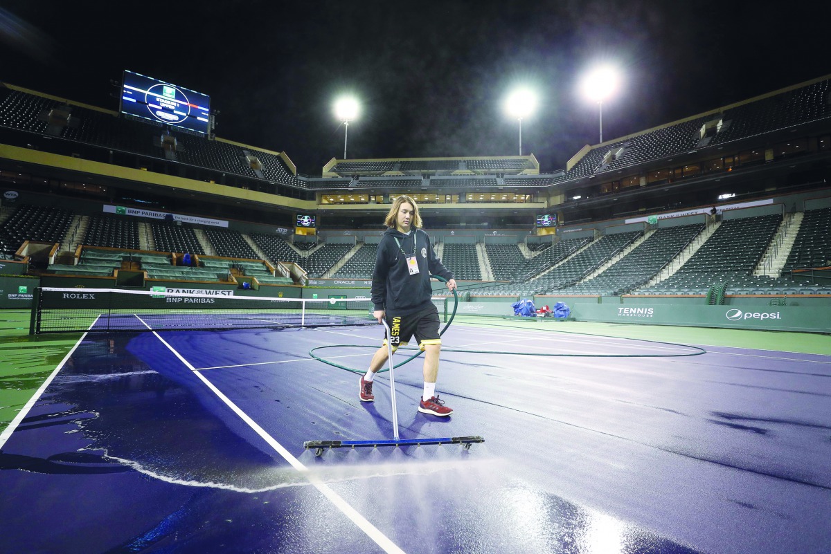 Courtmaster Jeffrey Brooker cleans the center court at the Indian Wells Tennis Garden on March 08, 2020 in Indian Wells, California. The BNP Paribas Open was cancelled by the Riverside County Public Health Department, as county officials declared a public