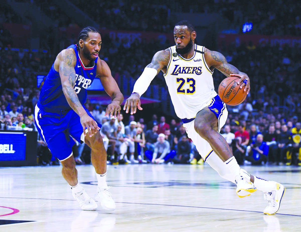 LeBron James #23 of the Los Angeles Lakers drives to the basket on Kawhi Leonard #2 of the LA Clippers during a 112-103 Lakers win at Staples Center on March 08, 2020 in Los Angeles, California.  Harry How/Getty Images/AFP