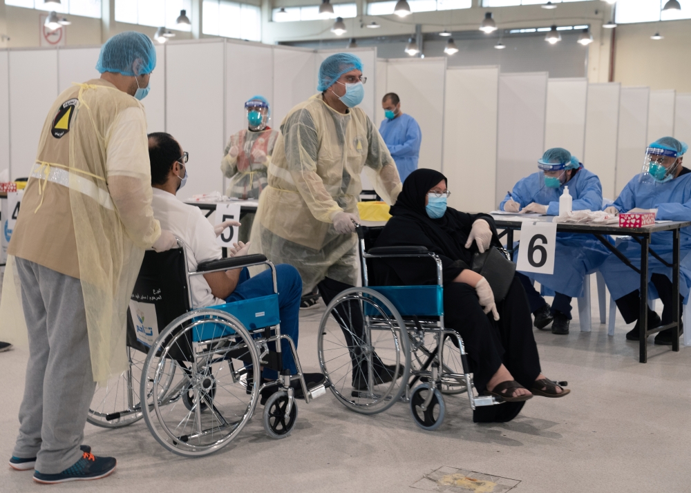 Volunteers help Kuwaitis, arriving from Europe, to do their compulsory testing at a coronavirus testing centre, at the Kuwait International Fairgrounds in Mishref, Kuwait March 18, 2020. REUTERS/Stephanie McGehee