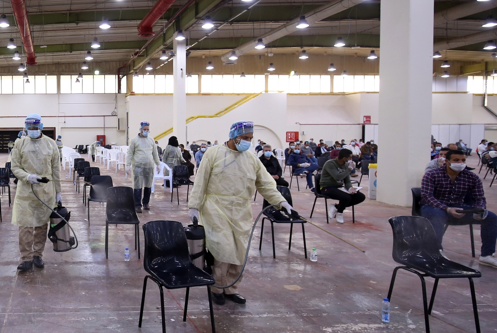 Expatriate returning from Egypt, Syria, and Lebanon arrive to be re-tested at a kuwaiti health ministry containment and screening zone for COVID-19 coronavirus disease in kuwait City on March 16, 2020. / AFP / YASSER AL-ZAYYAT