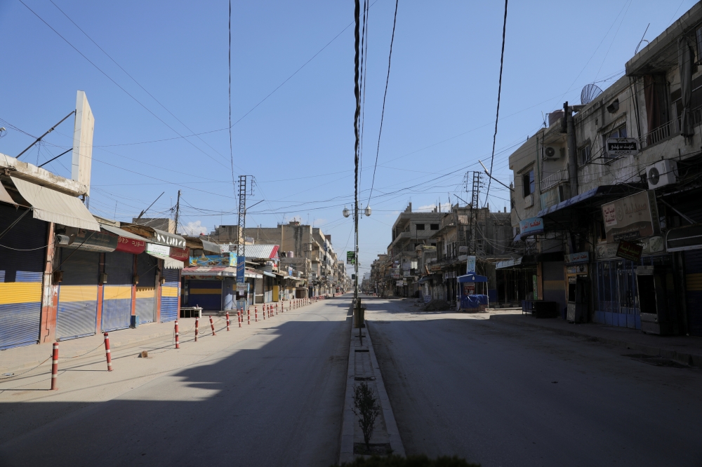 A view shows a closed shops along an empty street, as restrictions are imposed as measure to prevent the spread of the coronavirus disease (COVID-19) in Qamishli, Syria March 23, 2020. REUTERS/Rodi Said