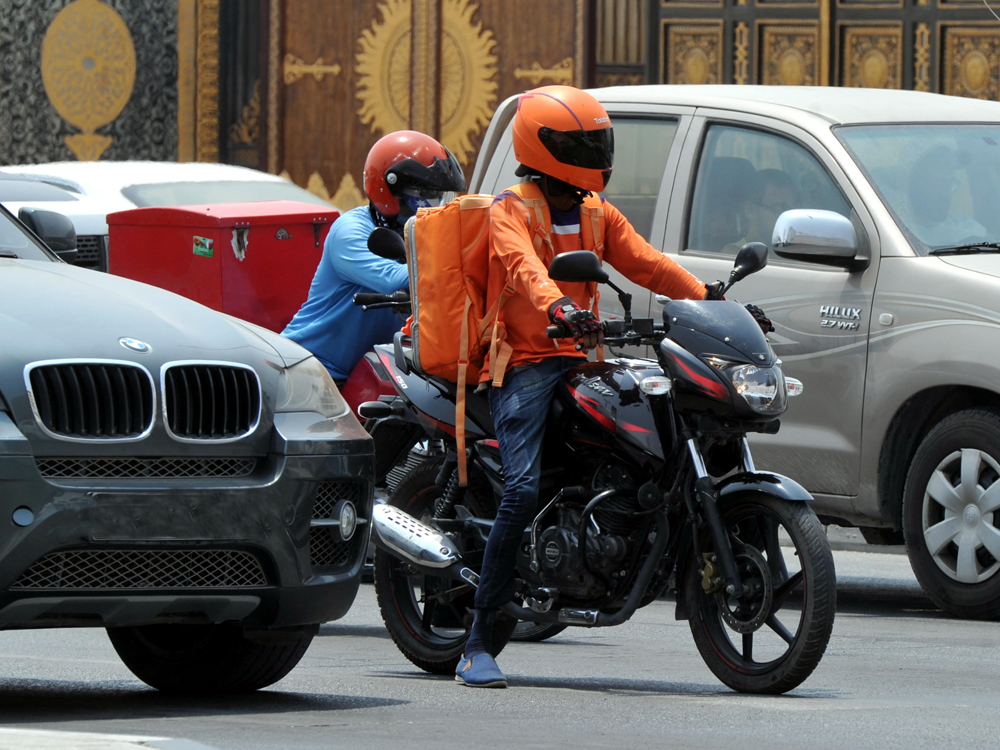 Delivery guys on Doha roads. Abdul Basit © The Peninsula