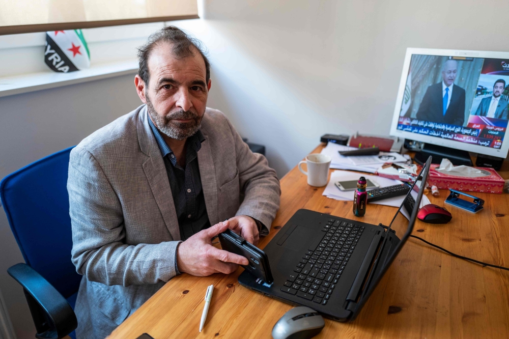 Syrian human rights lawyer Anwar al-Bunni poses in his office in Berlin on April 9, 2020. When Anwar al-Bunni crossed paths with fellow Syrian Anwar Raslan in a DIY store in Germany five years ago, he recognised him as the man who had thrown him into pris