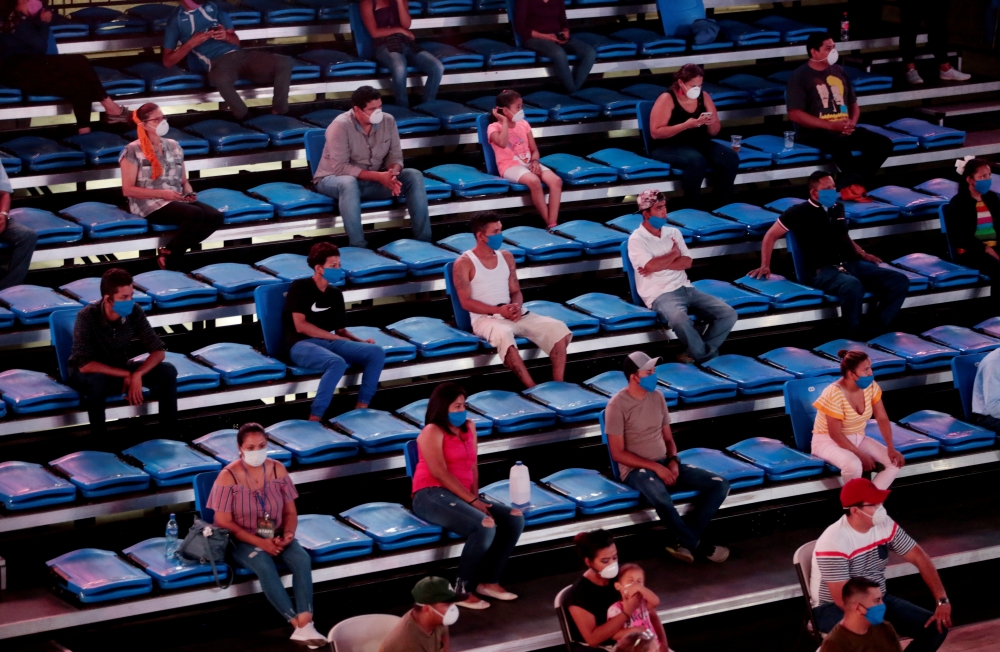 Fans wearing protective face masks are seated with social distancing during a boxing match in Managua, Nicaragua. (REUTERS/Oswaldo Rivas )