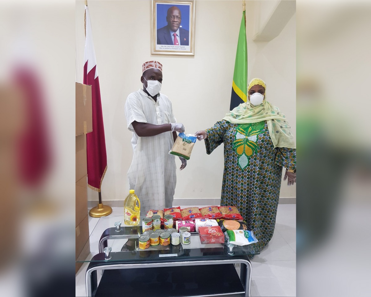 A Tanzanian community member receives food items, which were provided by the Qatar Charity, from Fatma Mohammed Rajab, Ambassador of Tanzania to Qatar.  