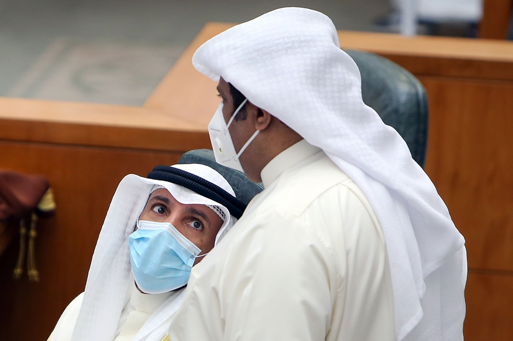 Kuwaiti parliament speaker Marzouq al-Ghanim (L) speaks to MP al-Humaidi al-Subaie during a parliament session at the national assembly in Kuwait City, on June 16, 2020. / AFP / YASSER AL-ZAYYAT