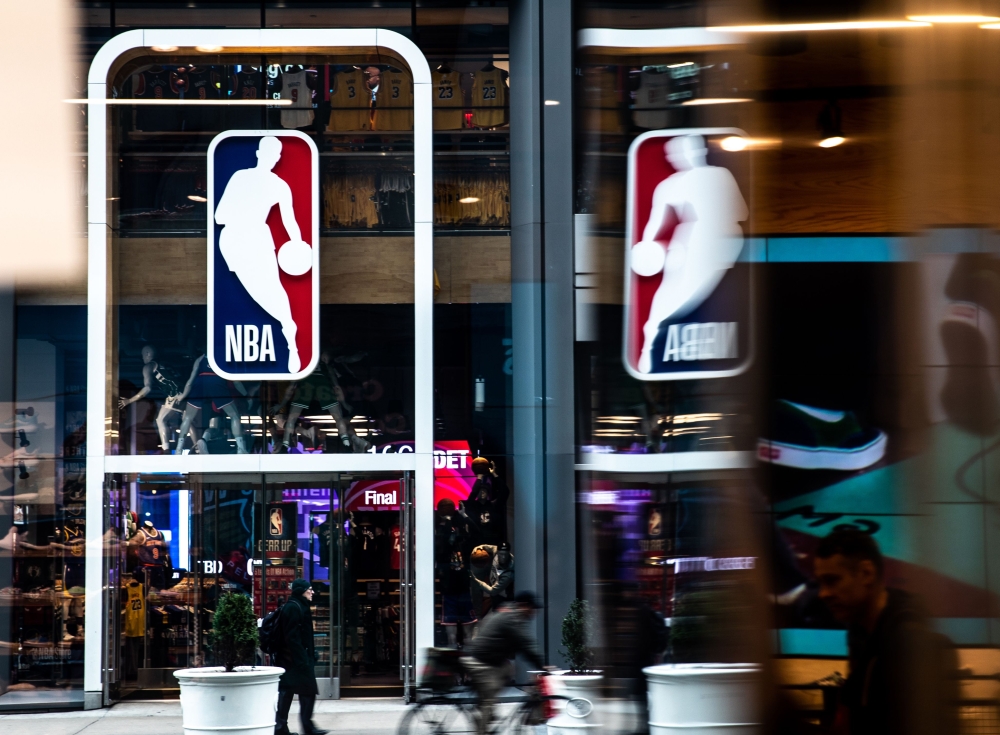 (FILES) In this file photo taken on March 12, 2020, an NBA logo is shown at the 5th Avenue NBA store in New York City. The NBA has settled upon key dates for the upcoming resumption of its coronavirus-halted 2019-20 season, including an October NBA Finals