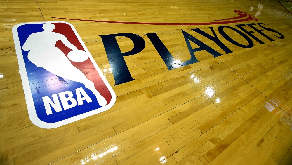 (FILES) In this file photo taken on April 27, 2013, the NBA and Playoffs logo is seen on the court before the game between the Oklahoma City Thunder and Houston Rockets in Houston, Texas. / AFP /  SCOTT HALLERAN
 