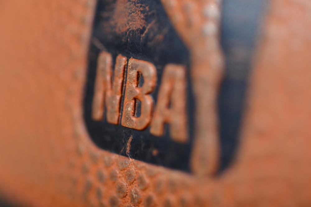 In this file photo taken on January 08, 2013 A detail view of the Spalding ball with NBA logo is seen during the game between the Orlando Magic and the Denver Nuggets at the Pepsi Center in Denver, Colorado. The NBA said July 13, 2020 two players have tes