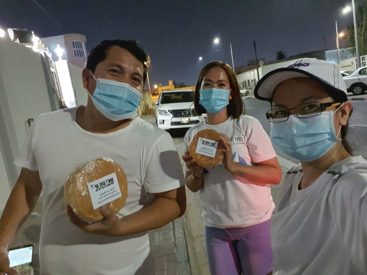 Rose Buds Purificacion distributing free cakes to fellow countrymen.