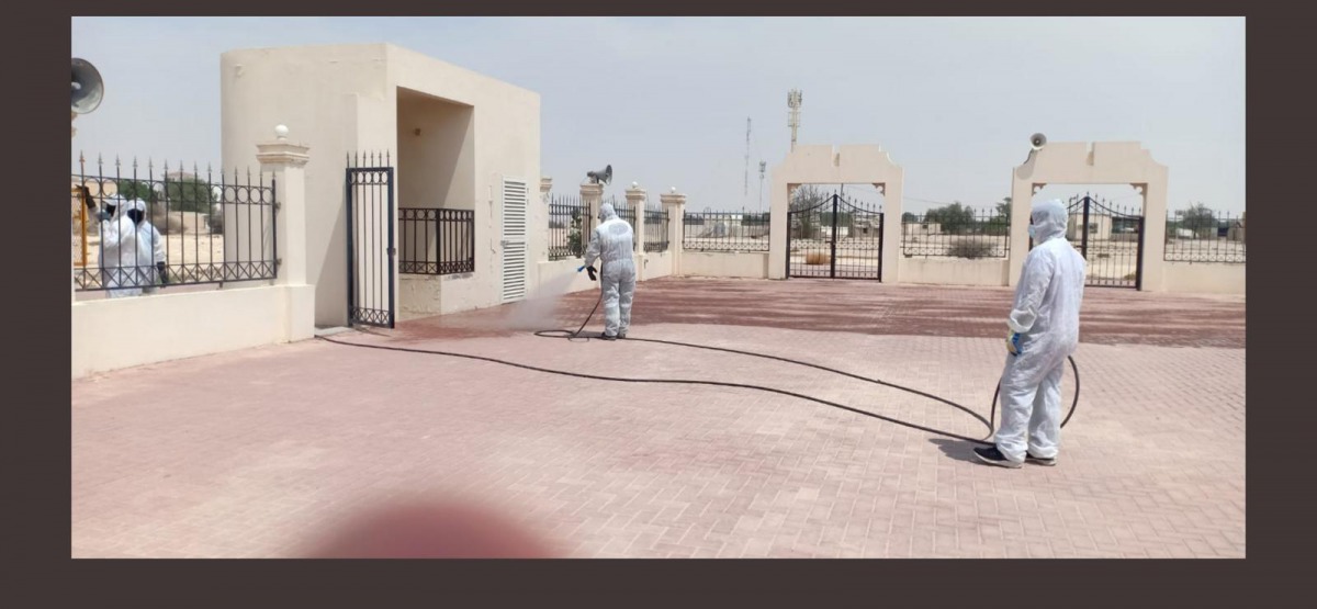 Workers washing and disinfecting prayer grounds to make it ready for Eid Al Adha prayer