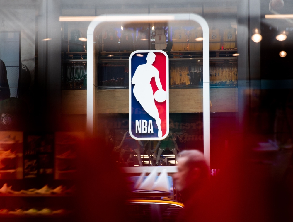 In this file photo taken on March 12, 2020, the NBA logo is shown at the 5th Avenue NBA store in New York City. The NBA reported zero positive COVID-19 cases for the fourth consecutive week on August 12, 2020, in the latest round of testing carried out at