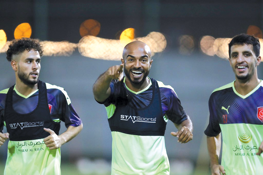 Al Duhail's Ali Afif (centre) trains with team-mates.