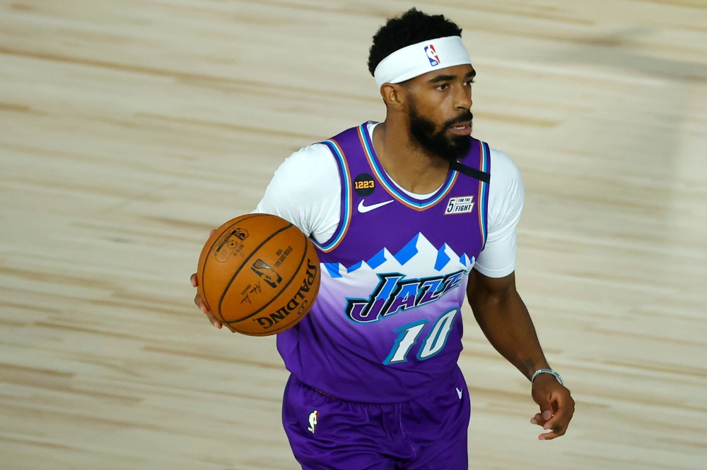 In this file photo taken on August 04, 2020 Mike Conley #10 of the Utah Jazz dribbles the ball against the Memphis Grizzlies during the first half at HP Field House at ESPN Wide World Of Sports Complex in Lake Buena Vista, Florida. / AFP / GETTY IMAGES NO