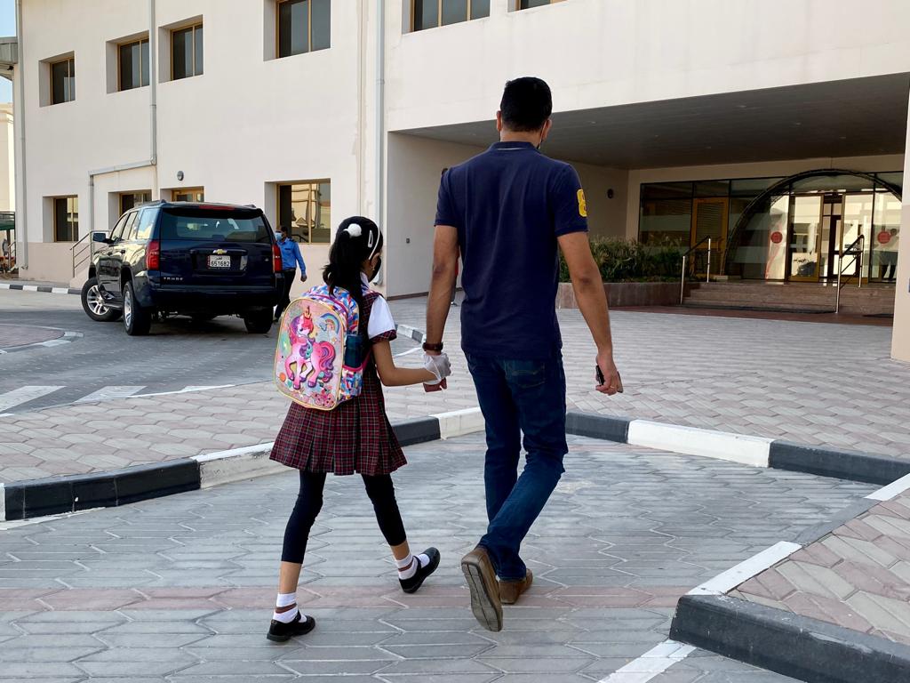 A parent dropping his daughter for the first day of school. Photo: Qassim Rehmatullah / The Peninsula 