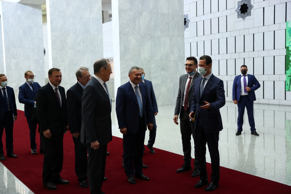 Russian Deputy Prime Minister Yuri Borisov, Foreign Minister Sergei Lavrov, Syrian President Bashar al-Assad and other officials attend a meeting in Damascus, Syria September 7, 2020. 