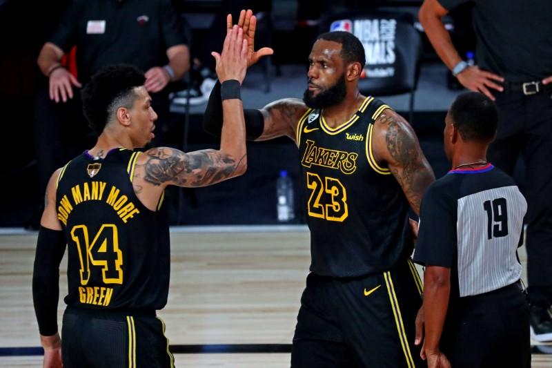 FILE PHOTO: Oct 2, 2020; Orlando, Florida, USA; Los Angeles Lakers forward LeBron James (23) celebrates with guard Danny Green (14) after a play during the third quarter against the Miami Heat in game two of the 2020 NBA Finals at AdventHealth Arena. REUT