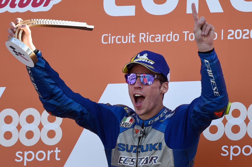 Suzuki Ecstar's Spanish rider Joan Mir celebrates on the podium after winning the MotoGP race of the European Grand Prix at the Ricardo Tormo circuit in Valencia on November 8, 2020. / AFP / JOSE JORDAN