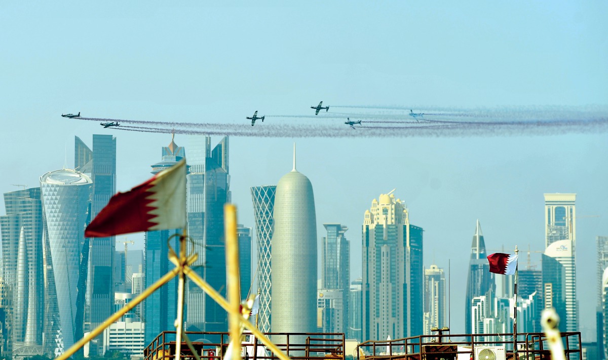 Aircraft taking part in a air show rehearsal to celebrate Qatar National Day over the Corniche skyline yesterday. Pic: Salim Matramkot/The Peninsula