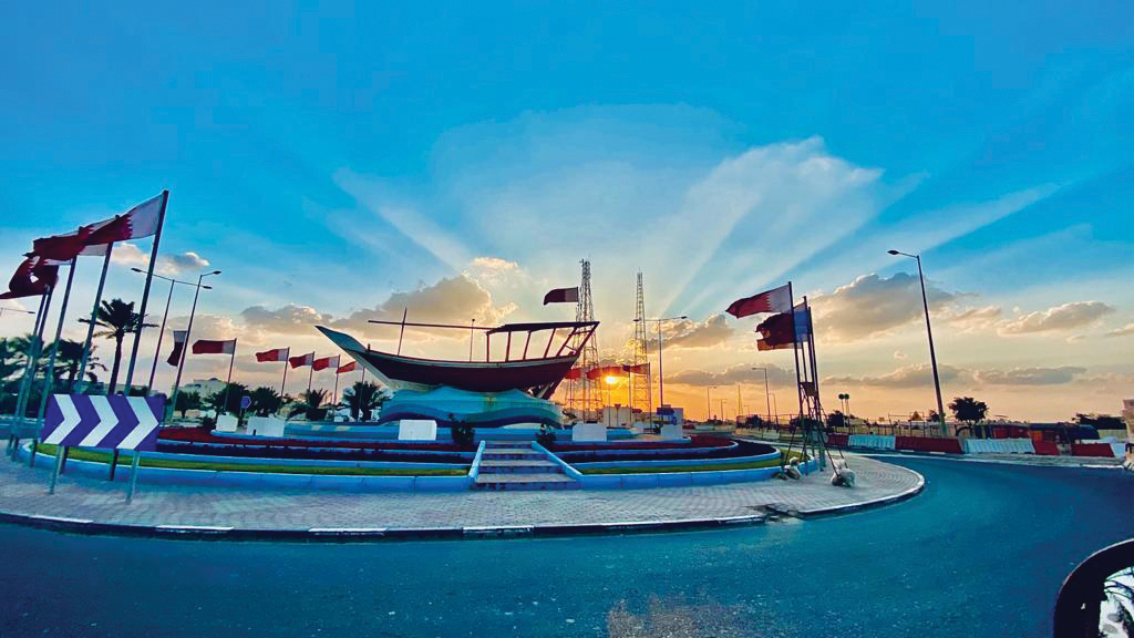 A roundabout decked up with flags and flowers in connection with Qatar National Day. 