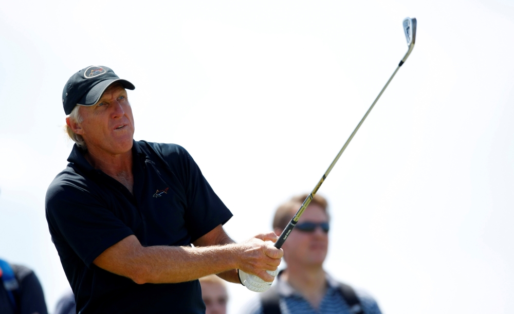 Greg Norman of Australia watches his tee shot on the sixth hole during a practice round ahead of the British Open Golf Championship at the Turnberry Golf Club in Scotland, July 15, 2009. REUTERS/Mike Blake/File Photo