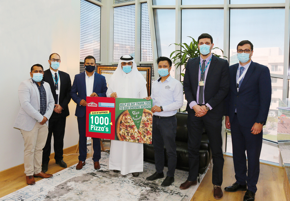 Representatives of Papa John’s Pizza handing vouchers to Nasser Al Naimi.