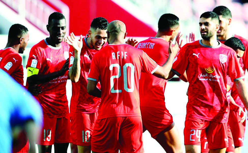 Al Duhail's Edmilson Junior celebrates with team-mates Almoez Ali and Ali Afif.