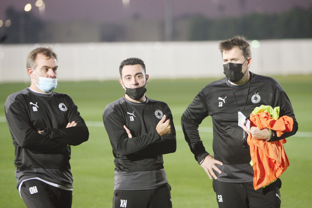 Al Sadd's coach Xavi Hernandez (centre) looks on during a practice session ahead of their QNB Stars League Round-15 match.