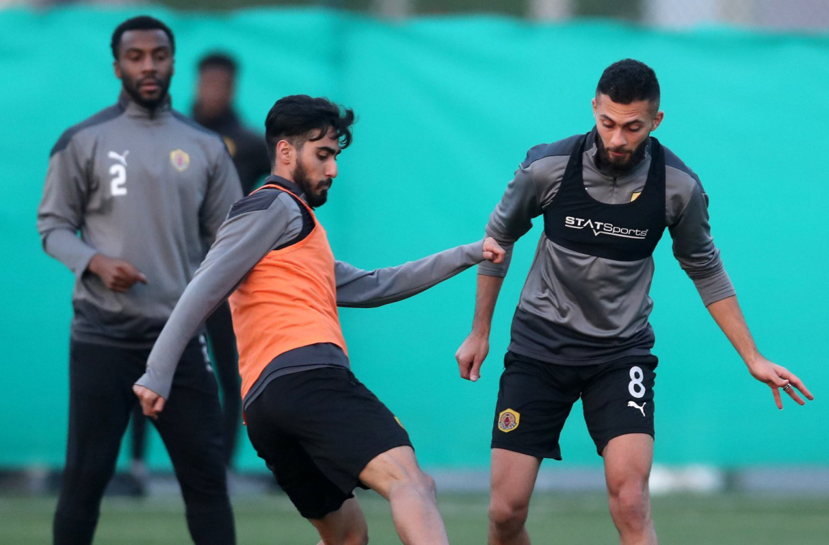 Qatar SC players in action during a training session yesterday.