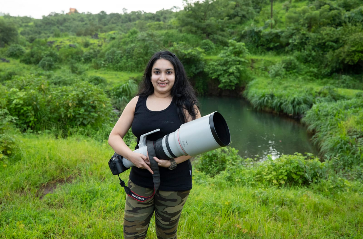 Aishwarya Sridhar, a wildlife photographer, poses with her camera.