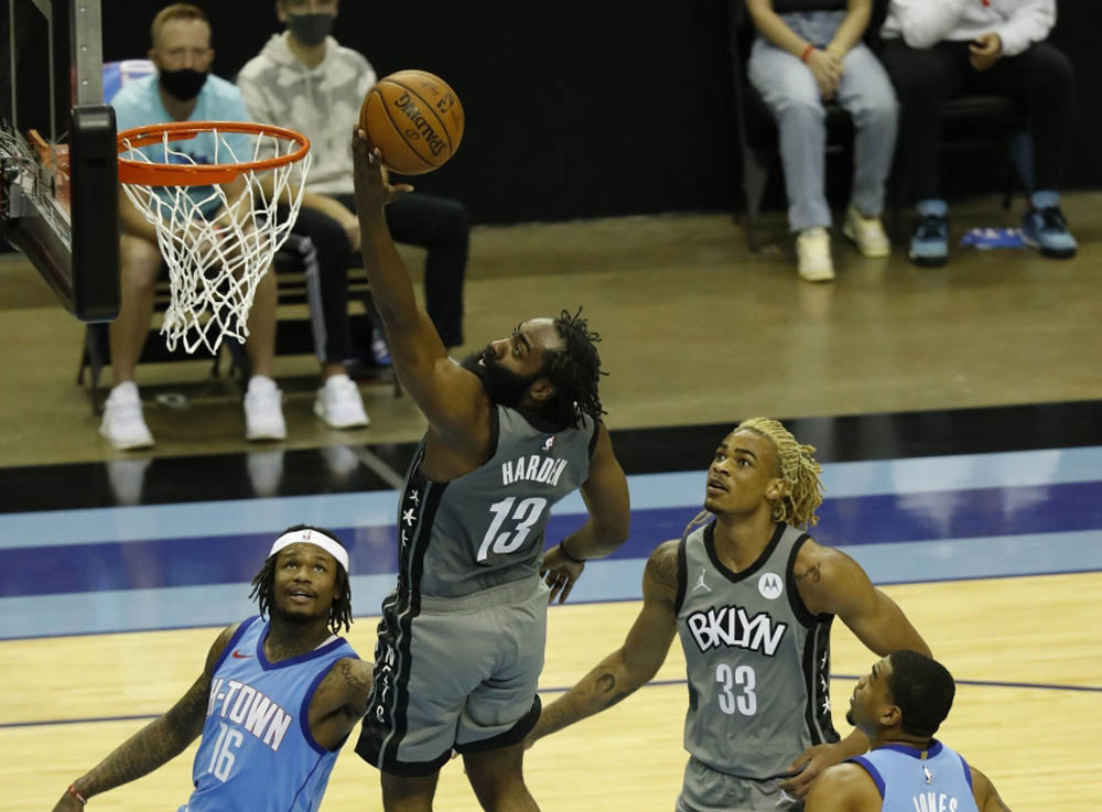 James Harden #13 of the Brooklyn Nets drives to basket for a layup past Ben McLemore #16 of the Houston Rockets during the second quarter at Toyota Center on March 03, 2021 in Houston, Texas. Bob Levey