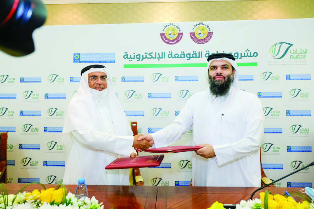 Director-General of General Endowment Department, Dr. Khalid bin Mohammad Al Thani, and Head of the Specialised Hospitals Group, Ali Abdul Qadir Al Jenahi, at the agreement signing ceremony.