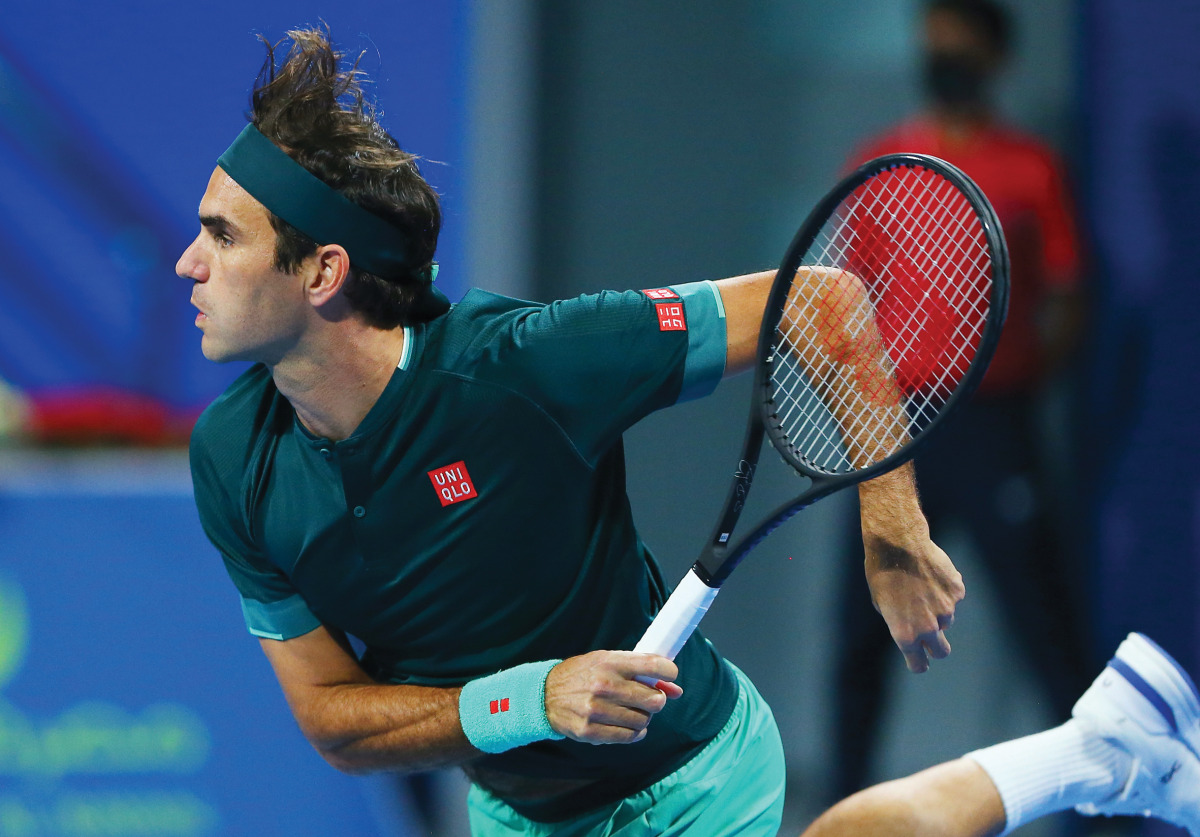 Roger Federer serves during his round of 16 match against Britain's Dan Evans at the Qatar ExxonMobil Open at the Khalifa International Tennis and Squash Complex yesterday. 