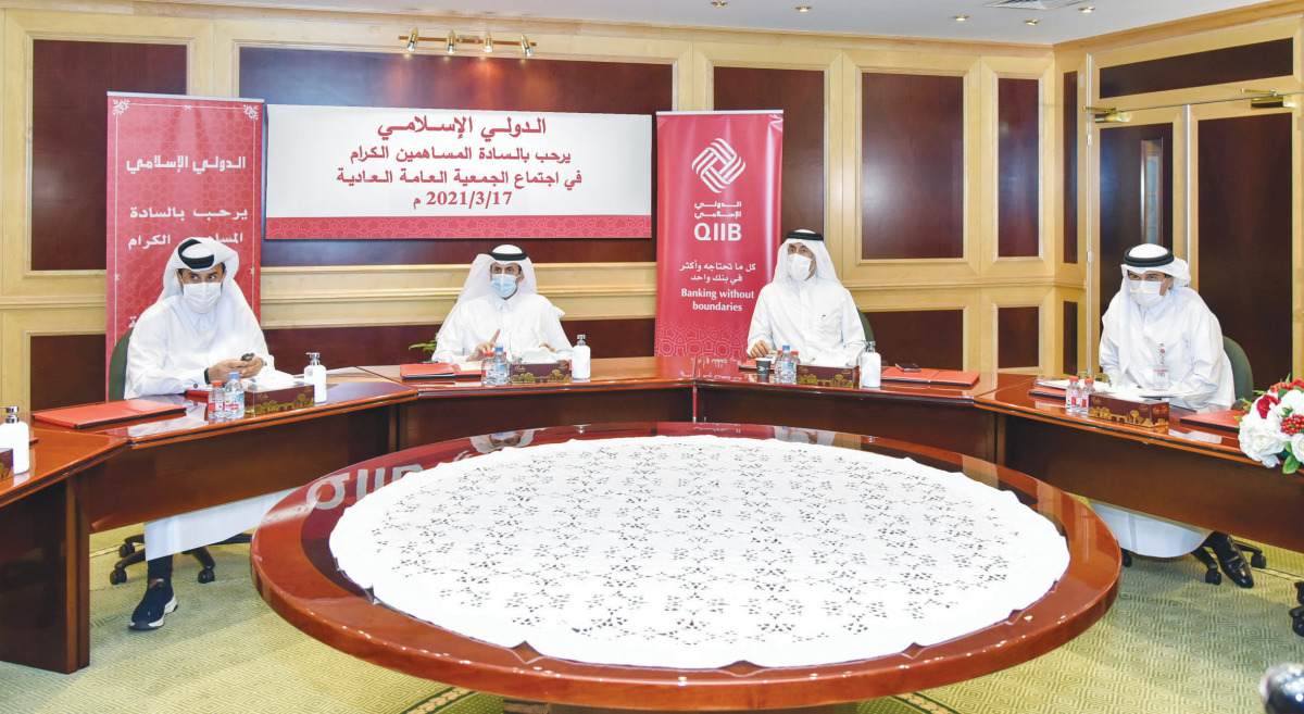 Sheikh Dr. Khalid bin Thani bin Abdullah Al Thani, Chairman of the Board and Managing Director, QIIB, and other officials during the meeting.