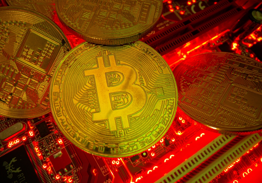 FILE PHOTO: Representations of the virtual currency Bitcoin stand on a motherboard in this picture illustration taken May 20, 2021. REUTERS/Dado Ruvic/Illustration