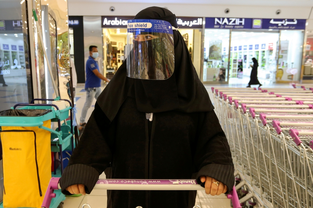 A Saudi woman, wearing a face shield, shops at a supermarket in Riyadh, Saudi Arabia. (REUTERS/Ahmed Yosri/File Photo)