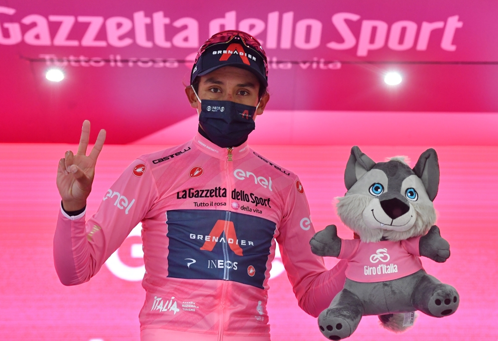 Ineos Grenadiers rider Egan Arley Bernal Gomez of Colombia celebrates wearing the maglia rosa on the podium after stage 16 REUTERS/Jennifer Lorenzini
